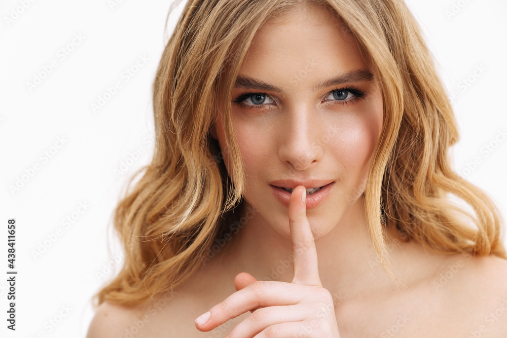 Half-naked blonde woman showing silence gesture at camera Half-naked blonde woman showing silence gesture at camera