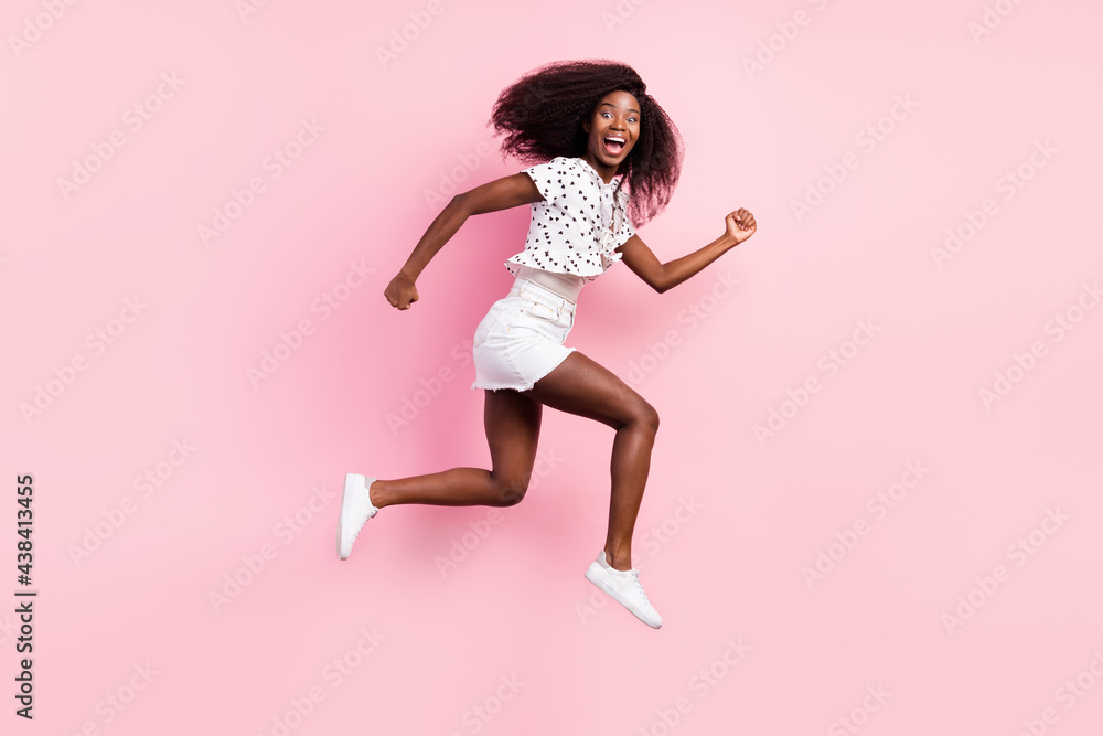 Full size profile side photo of young happy excited afro girl running in air fast speed isolated on blue color background