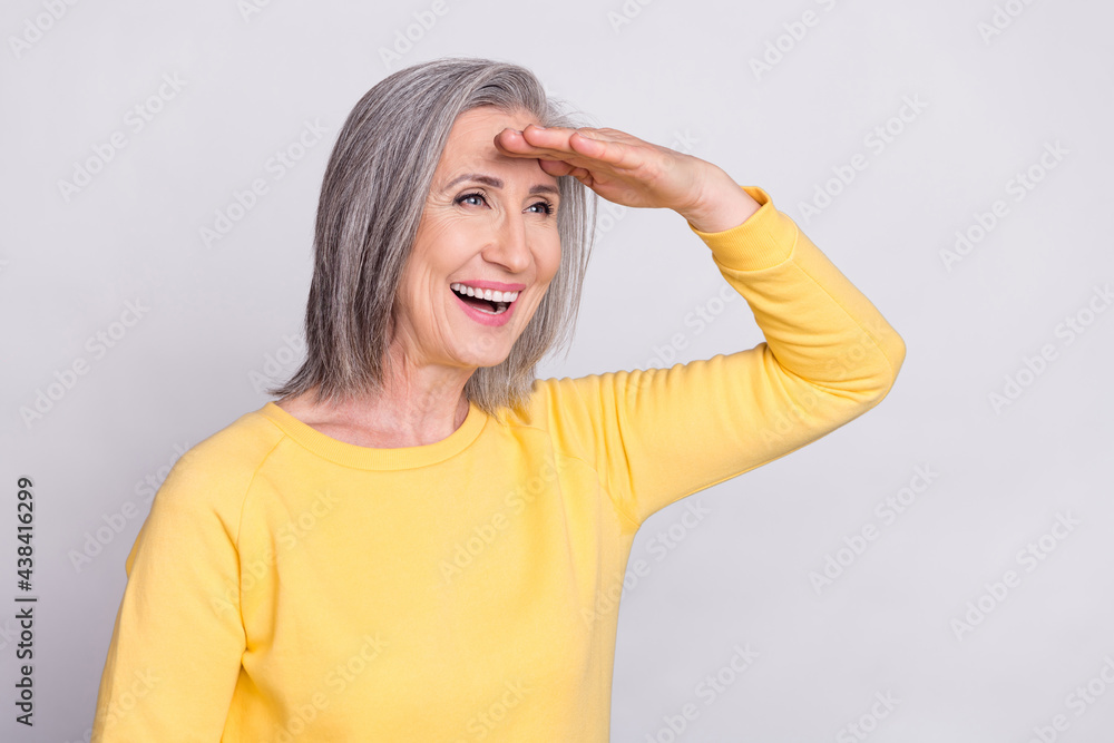 Photo of happy excited cheerful crazy mature woman look copyspace forward ahead isolated on grey color background Photo of happy excited cheerful crazy mature woman look copyspace forward ahead isolated on grey color background