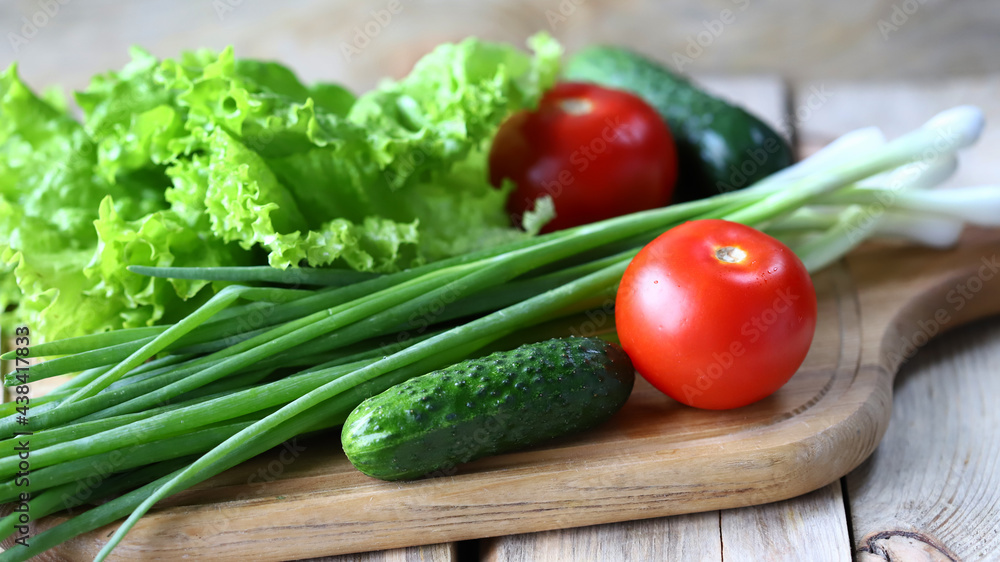 Set of greens on a wooden board. Green onions, salad, vegetables. Healthy diet. Salad products.
