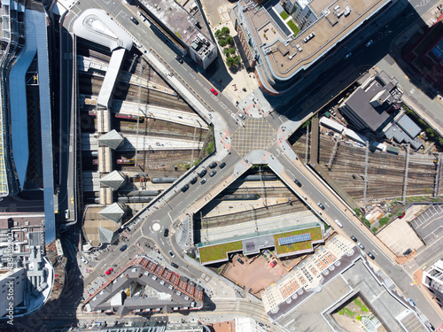 Birmingham New Street Grand Central Station England UK Aerial view of city centre with crossroads train station. Big transport hub with trains at platforms on sunny day drone perspective. © Matthew