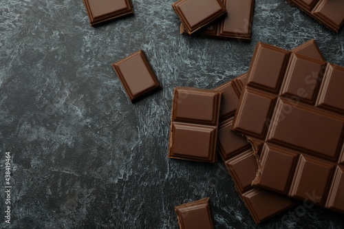 Tasty chocolate bars on black smokey background