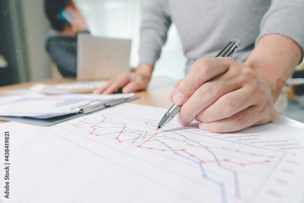 Hand of businessman point to graph. is discussing together in conference room talk about Report, Sales, Target, Marketing, Hand of businessman point to graph. is discussing together in conference room talk about Report, Sales, Target, Marketing,