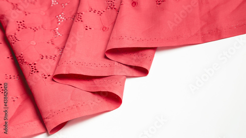 Beautiful red cotton fabric with sewing as a background. Fashion and design conceptю Сщзн ызфсу