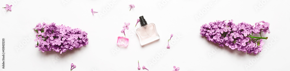 Spring flowers. Floral scent concept. elegant Perfume bottle with lilac flowers over white background. Top view, flat layer. Banner