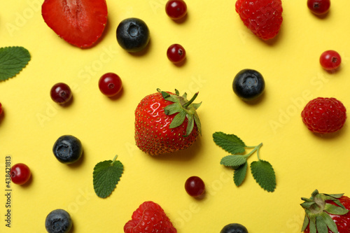 Fototapeta Naklejka Na Ścianę i Meble -  Delicious fresh berry mix on yellow background