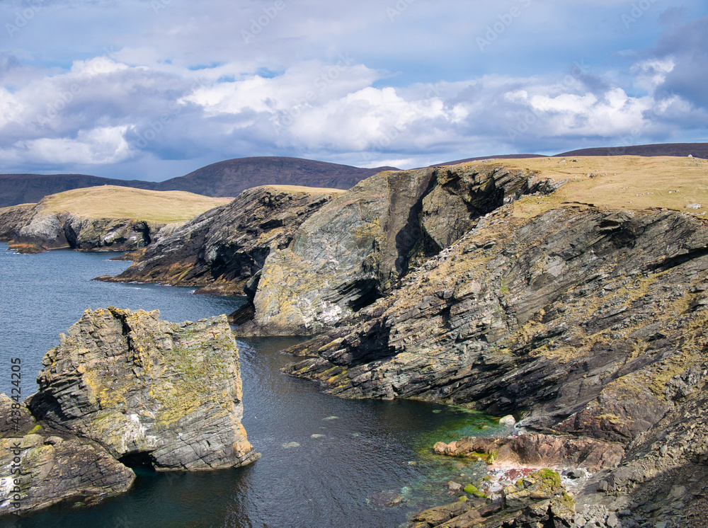 Inclined strata in coastal rock at Kenna Ness, Shetland, UK. An unnamed igneous intrusion, late Silurian to early Devonian - Felsic-rock. Igneous bedrock formed 398 to 423 million years ago. Inclined strata in coastal rock at Kenna Ness, Shetland, UK. An unnamed igneous intrusion, late Silurian to early Devonian - Felsic-rock. Igneous bedrock formed 398 to 423 million years ago.