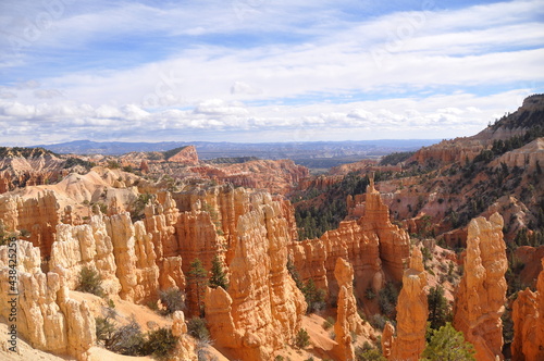 Great pan view of pinnacles with huge rocky landscape and cliffs under cloudy sky in Paunsaugunt Plateau of Bryce Canyon National Park, USA