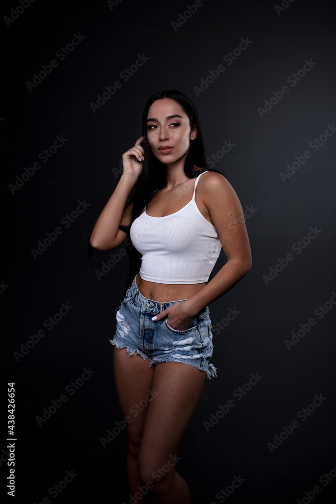 portrait of a young woman in the studio on a dark background portrait of a young woman in the studio on a dark background