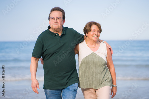lifestyle portrait of loving happy and sweet mature couple - senior retired husband and wife on 70s enjoying beach walk relaxed and cheerful celebrating love together