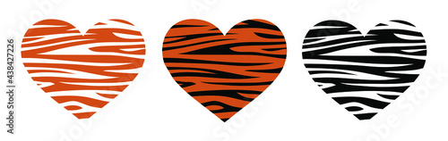 Tiger is the symbol of 2022. Heart in tiger coloring . Three hearts in a predatory coloring texture of exotic animals.