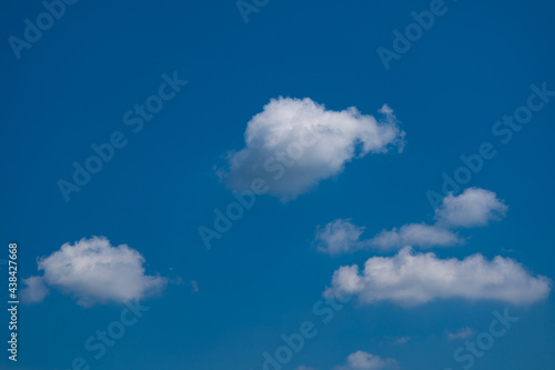 White clouds in shiny day blue background on sky