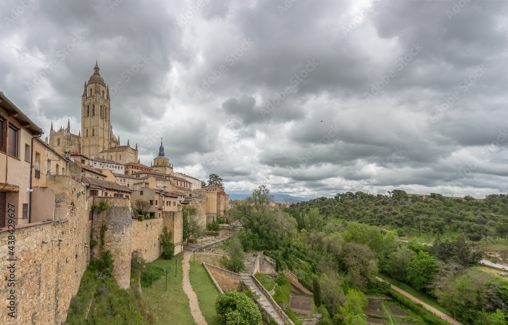 Majestic view at the iconic Segovia city fortress and surrounding vegetation, spanish gothic building at the Segovia cathedral, tower