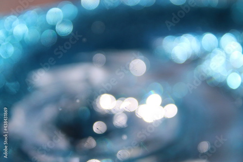 Wallpapers. Frozen movement of water. Drops of water falling and splashing. Sparkles, reflections of light. Light blue color. 