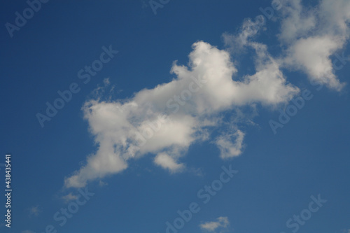 White clouds in the blue sky. Horizontal frame.