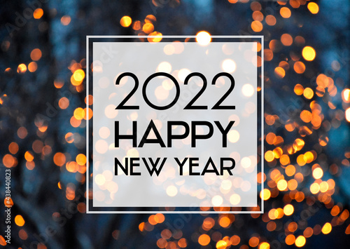 2022 Happy New Year christmas golden bokeh lights background frame stock images. 2022 New Year sign on a glowing background. Happy New Year 2022 night defocused lights texture greeting card images