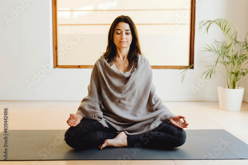 Young woman sitting in lotus position photo