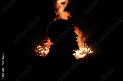 Photos Profile of a man with a beard against the background of fire