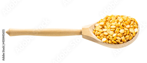 wooden spoon with dried split yellow peas isolated