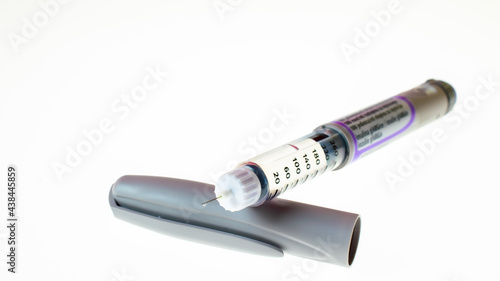 Insulin pen injector. Insulin pen fill with needle on white background. Diabetes Day.