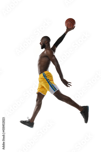 Full length portrait of a basketball player with a ball isolated on white studio background. advertising concept. Fit african american athlete jumping with ball. © master1305