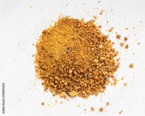 pile of granulated coconut blossom sugar on gray