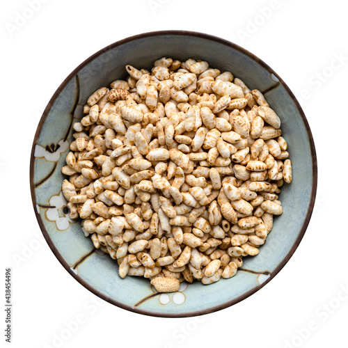 Fotografija top view of puffed brown rice in bowl isolated