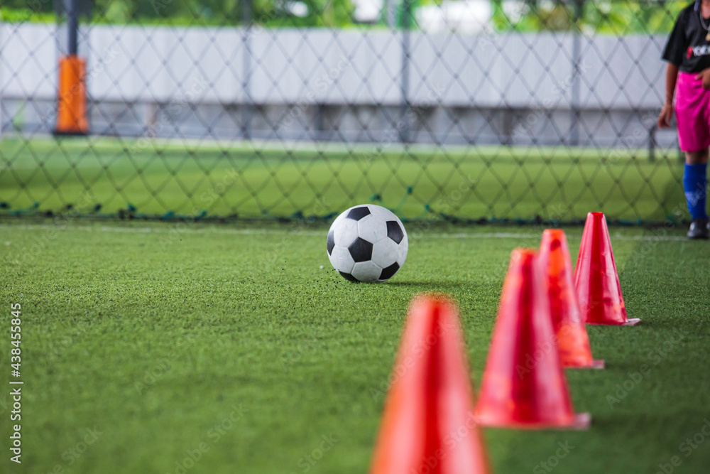 Obraz premium Soccer ball tactics cone on grass field with for training background