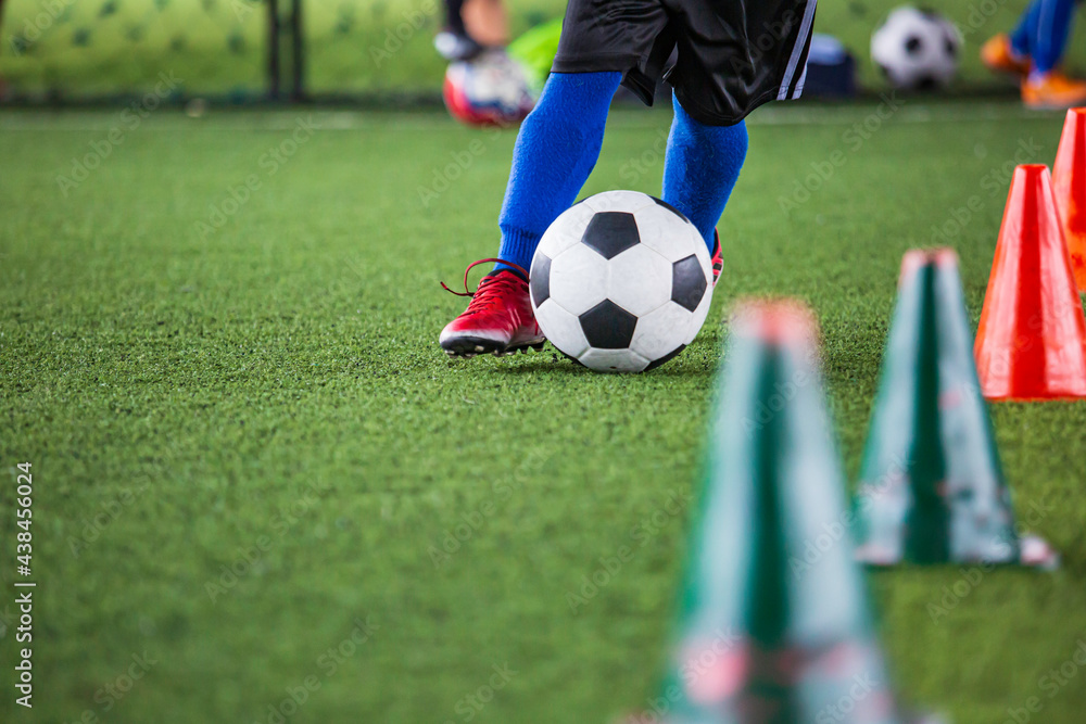 Children playing control soccer ball tactics on grass field with for training