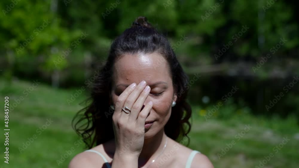 A woman does breathing exercises. A woman who attains harmony with nature through meditation. Concept of active, meditate, fitness, relax A woman does breathing exercises. A woman who attains harmony with nature through meditation. Concept of active, meditate, fitness, relax