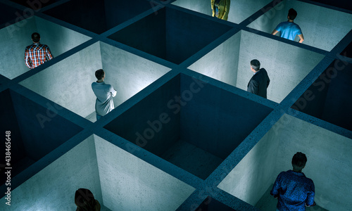 Fotografi people trapped in small concrete rooms with sectors.