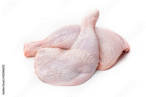 Raw chicken thighs with skin on a white background.