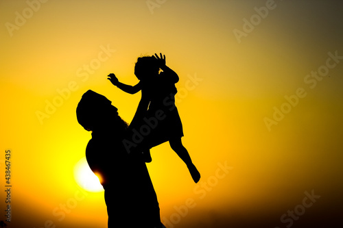 silhouette of a man playing with his child  Father s day 