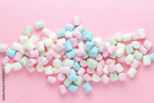 Colorful marshmallows background close up. Marshmallows on pink background