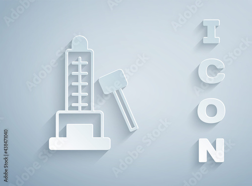 Paper cut High striker attraction with big hammer icon isolated on grey background. Attraction for measuring strength. Amusement park. Paper art style. Vector