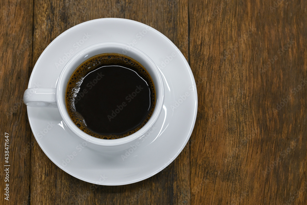 Fototapeta premium top view of black coffee in white seramic glasses on old background
