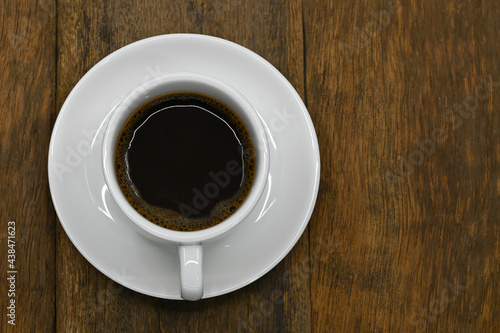 black coffee in white seramic glasses on an old wooden floor