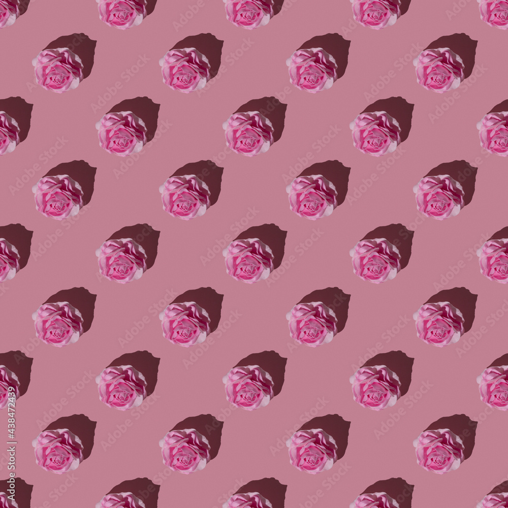 Seamless pattern with many pink roses on a pink background under hard light. Seamless pattern with many pink roses on a pink background under hard light.
