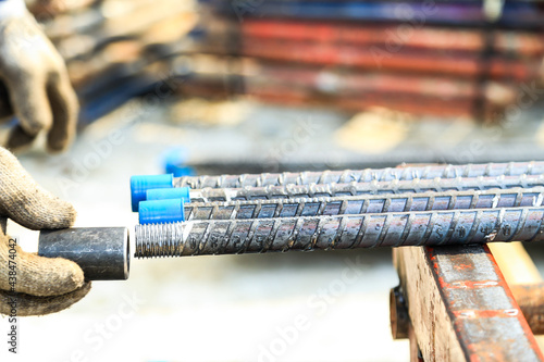 Rebar with threaded ends and a joint called a coupler.