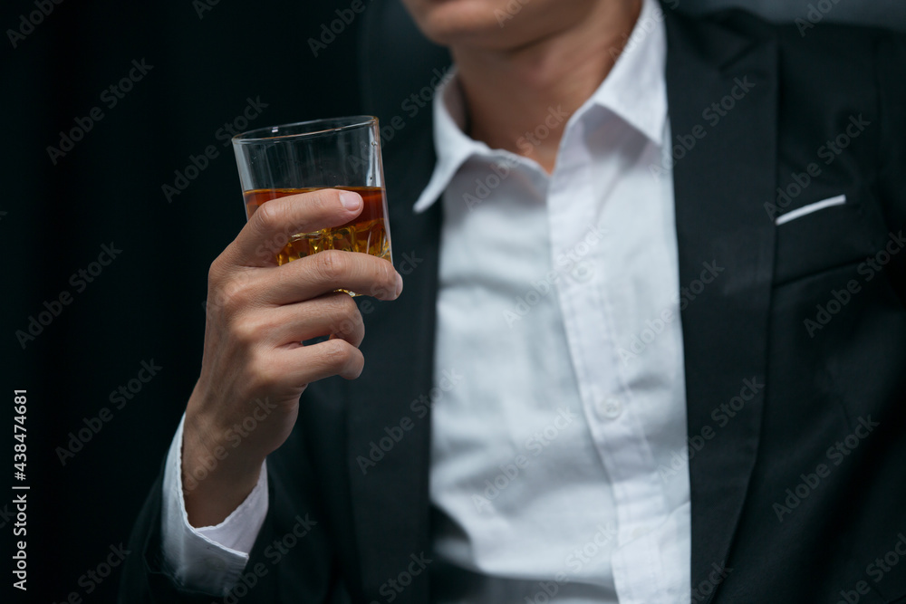 Man wearing a suit whiskey glass of liquor Man wearing a suit whiskey glass of liquor