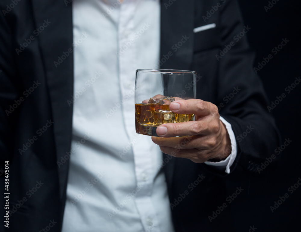 Man wearing a suit whiskey glass of liquor Man wearing a suit whiskey glass of liquor