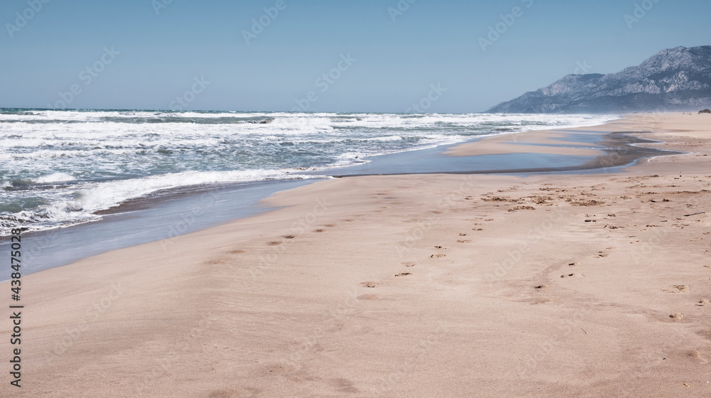 The wide Patara beach on the Mediterranean coast with sand dunes in Turkey