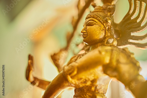 multi-armed eastern deity statue in bright window