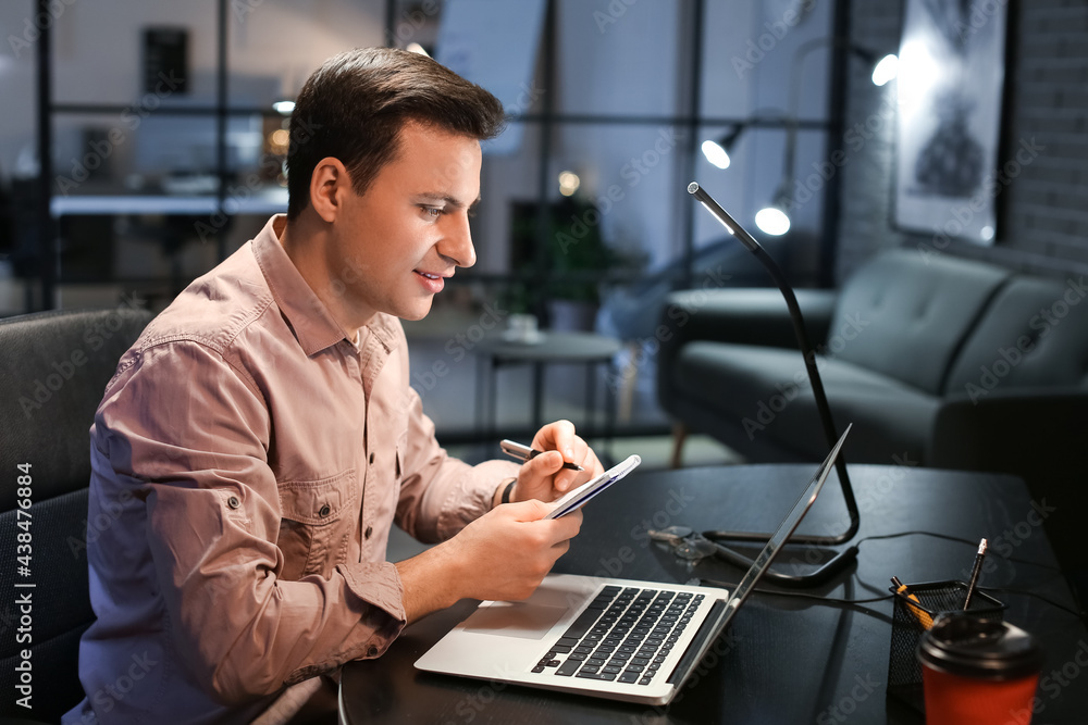 Handsome man working at home late in evening Handsome man working at home late in evening