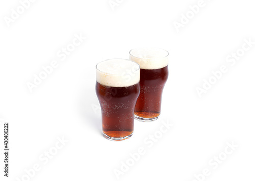 A glasses of dark beer isolated on a white background. Dark beer.