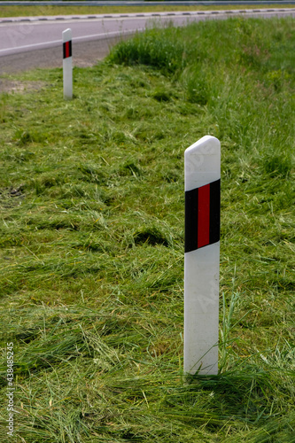 Принти на полотні Warning poles along the road with mown grass