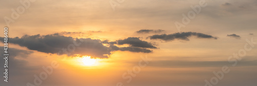 Panorama orange sunset sky with sun and cloud. Using as nature cover page.