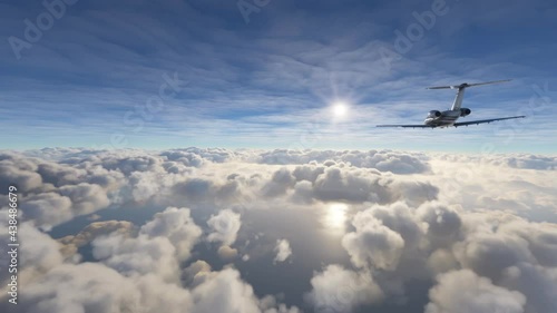 Private airplane flying over clouds: Aerial view of a small jet plane during a flight over the ocean