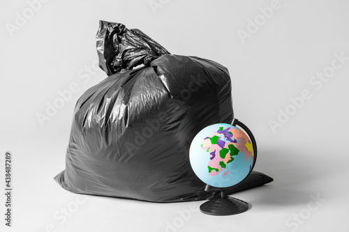 Bag with garbage and globe ...