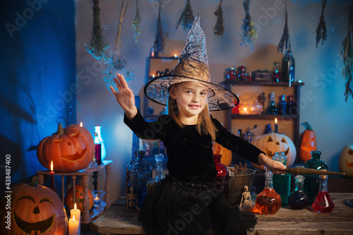 beautiful little witch with Halloween decorations